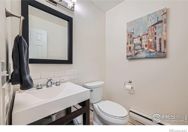 2977 Eagle Way, Boulder, CO 80301 - bathroom featuring a baseboard heating unit, decorative backsplash, toilet, and vanity