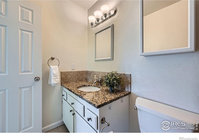 2977 Eagle Way, Boulder, CO 80301 - half bath with vanity, toilet, tasteful backsplash, and tile patterned flooring