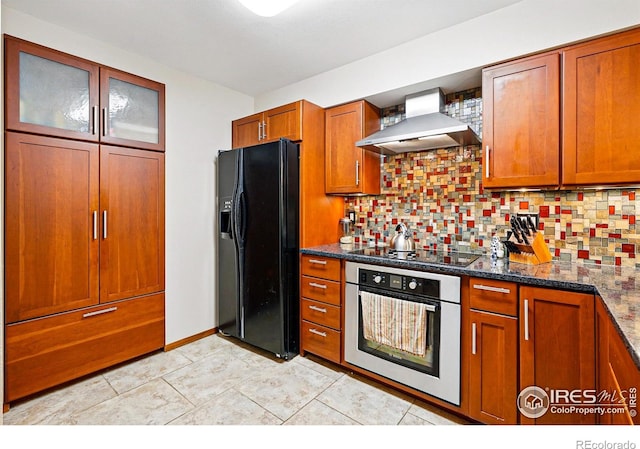 4489 Wellington Rd, Boulder, CO 80301 - kitchen with black appliances, wall chimney range hood, brown cabinets, backsplash, and glass insert cabinets