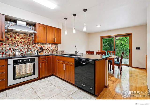 4489 Wellington Rd, Boulder, CO 80301 - kitchen with black appliances, a sink, wall chimney range hood, a peninsula, and brown cabinets