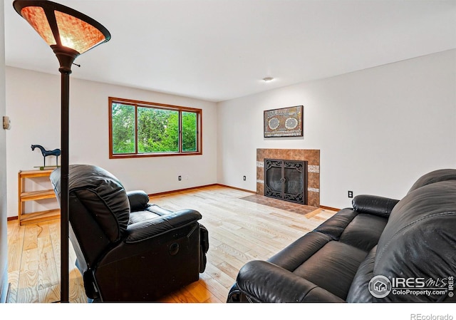 4489 Wellington Rd, Boulder, CO 80301 - living room with light wood-style flooring, baseboards, and a fireplace