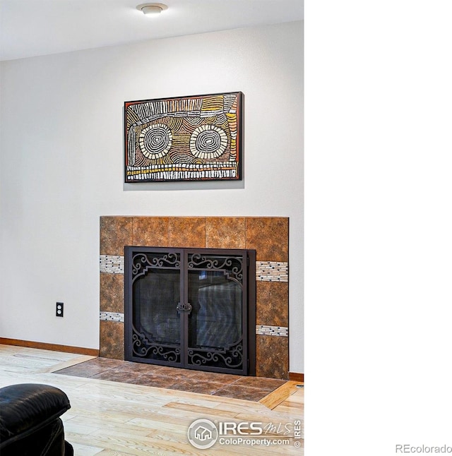4489 Wellington Rd, Boulder, CO 80301 - detailed view of a tiled fireplace, wood finished floors, and baseboards
