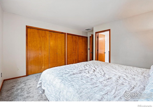 4489 Wellington Rd, Boulder, CO 80301 - carpeted bedroom featuring two closets and baseboards
