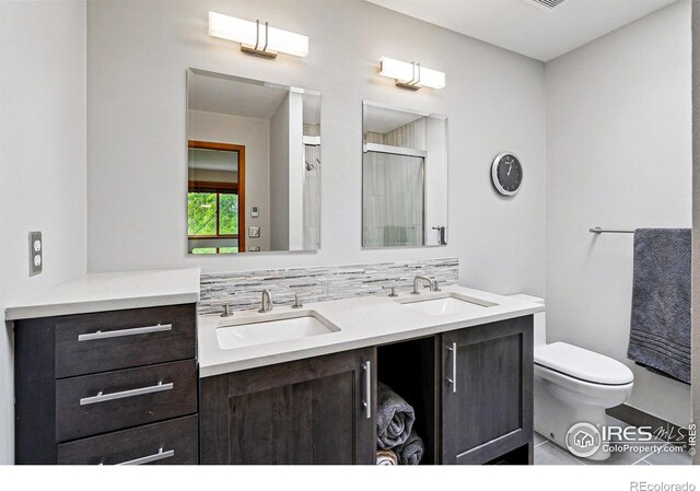 4489 Wellington Rd, Boulder, CO 80301 - full bath featuring double vanity, toilet, and a shower with shower door