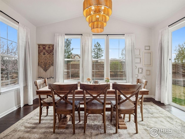 610 Sun Up Pl, Erie, CO 80516 - dining space with vaulted ceiling, plenty of natural light, a chandelier, and baseboards