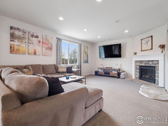 610 Sun Up Pl, Erie, CO 80516 - carpeted living area with recessed lighting, a stone fireplace, and baseboards