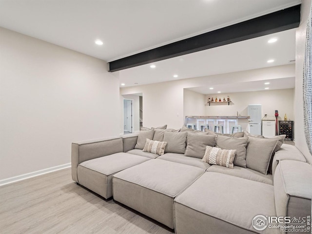 610 Sun Up Pl, Erie, CO 80516 - living room featuring wet bar, recessed lighting, light wood-style flooring, and baseboards