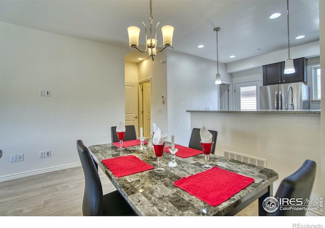 1240 Wren Ct Unit B, Longmont, CO 80501 - dining space featuring light wood-type flooring, a chandelier, recessed lighting, and baseboards
