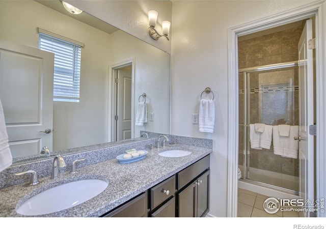 1240 Wren Ct Unit B, Longmont, CO 80501 - bathroom with double vanity, a stall shower, toilet, and tile patterned flooring