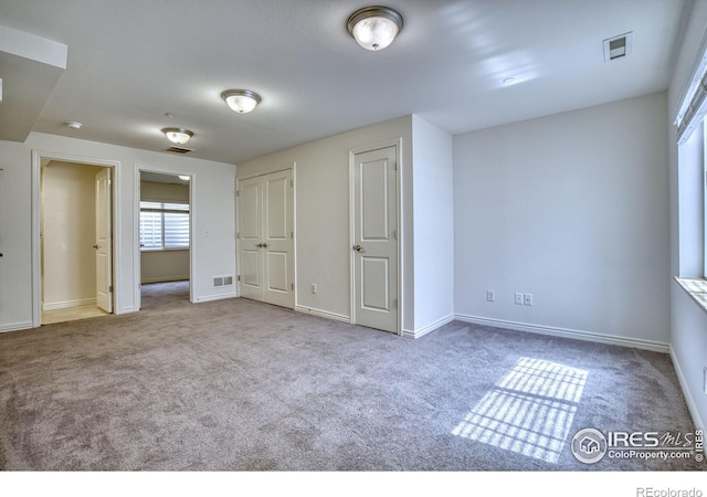 1240 Wren Ct Unit B, Longmont, CO 80501 - unfurnished bedroom with carpet, baseboards, and multiple closets