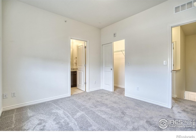 1240 Wren Ct Unit B, Longmont, CO 80501 - unfurnished bedroom with carpet flooring, a spacious closet, baseboards, and connected bathroom