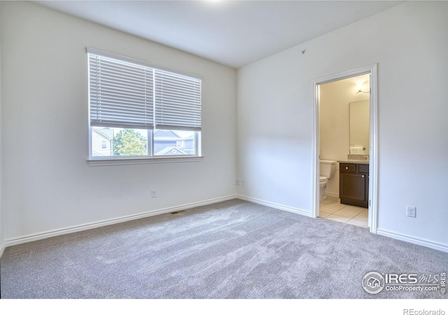 1240 Wren Ct Unit B, Longmont, CO 80501 - unfurnished bedroom with light carpet, baseboards, and ensuite bath