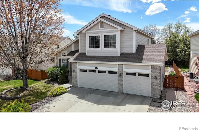 2139 Andrews St, Fort Collins, CO 80528 - traditional-style home featuring brick siding, driveway, a shingled roof, and a garage