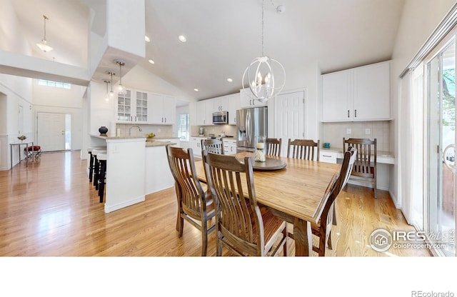 2139 Andrews St, Fort Collins, CO 80528 - dining space with high vaulted ceiling, a chandelier, light wood-type flooring, and recessed lighting