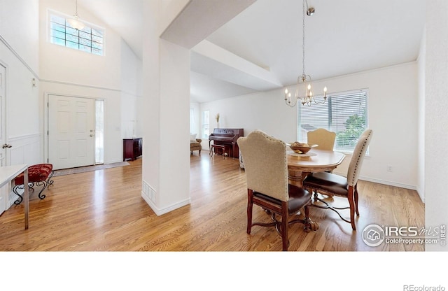 2139 Andrews St, Fort Collins, CO 80528 - dining area featuring a chandelier, plenty of natural light, light wood-style flooring, a high ceiling, and baseboards
