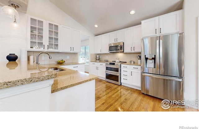 2139 Andrews St, Fort Collins, CO 80528 - kitchen with stainless steel appliances, a sink, lofted ceiling, glass insert cabinets, and white cabinetry