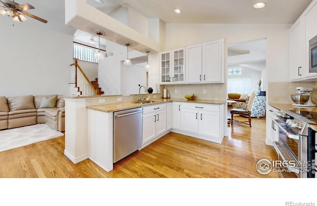 2139 Andrews St, Fort Collins, CO 80528 - kitchen with appliances with stainless steel finishes, a sink, open floor plan, glass insert cabinets, and healthy amount of natural light