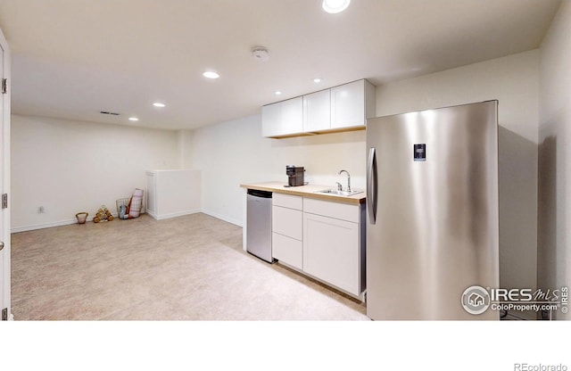 2139 Andrews St, Fort Collins, CO 80528 - kitchen with stainless steel appliances, a sink, white cabinets, recessed lighting, and light countertops