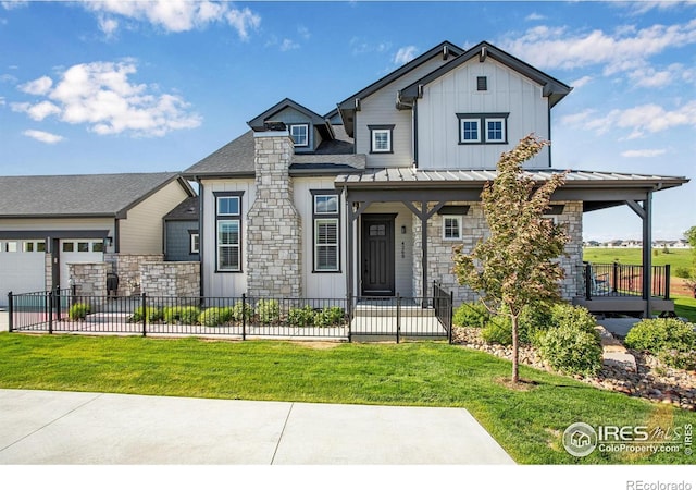 4268 Ardglass Ln, Timnath, CO 80547 - view of front facade featuring stone siding, covered porch, board and batten siding, and a garage