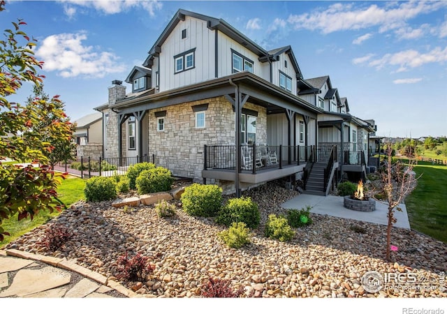 4268 Ardglass Ln, Timnath, CO 80547 - view of property exterior with board and batten siding, stone siding, and a porch