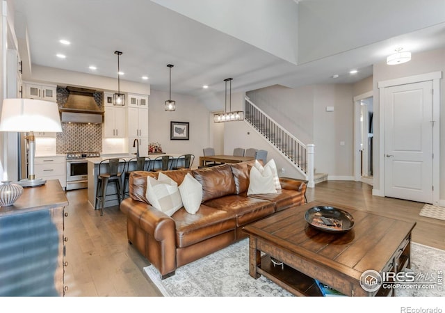 4268 Ardglass Ln, Timnath, CO 80547 - living room featuring stairway, light wood-style flooring, and recessed lighting