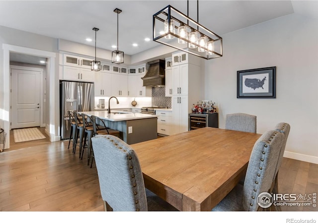 4268 Ardglass Ln, Timnath, CO 80547 - dining area featuring wood finished floors, recessed lighting, baseboards, and wine cooler