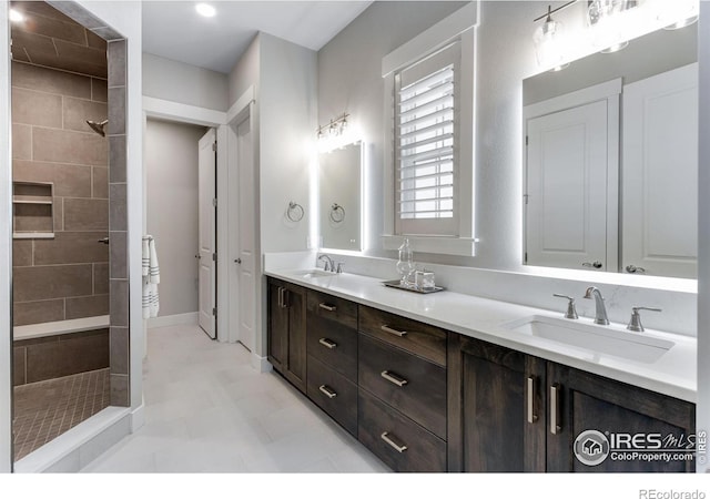 4268 Ardglass Ln, Timnath, CO 80547 - bathroom featuring double vanity, a tile shower, and tile patterned floors