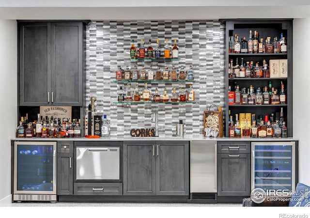 4268 Ardglass Ln, Timnath, CO 80547 - indoor dry bar with beverage cooler, built in refrigerator, and tasteful backsplash