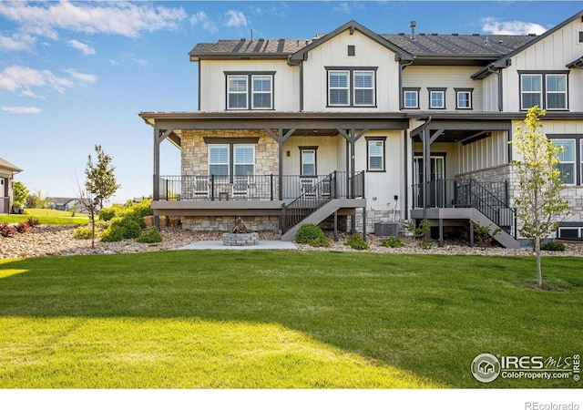 4268 Ardglass Ln, Timnath, CO 80547 - view of front facade with stairs, a front yard, covered porch, and stone siding