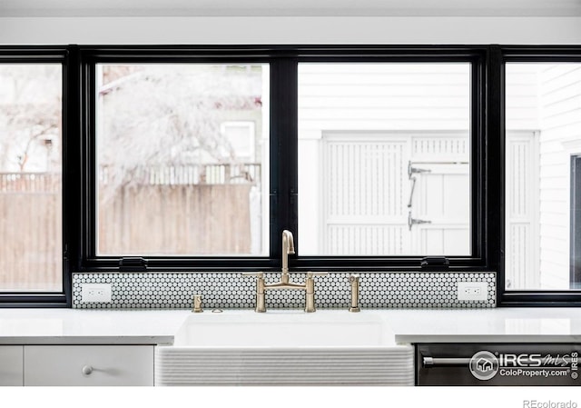 920 Hawthorn Ave, Boulder, CO 80304 - detailed view of a sink, decorative backsplash, light countertops, and white cabinetry