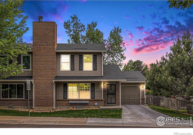 4116 W 111th Cir, Westminster, CO 80031 - traditional home featuring an attached garage, driveway, a chimney, and brick siding