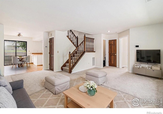 4116 W 111th Cir, Westminster, CO 80031 - living area featuring stairway, light colored carpet, baseboards, and recessed lighting