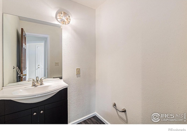 4116 W 111th Cir, Westminster, CO 80031 - bathroom with vanity, baseboards, and wood finished floors