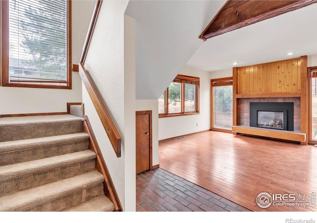 4570 Macarthur Dr, Boulder, CO 80303 - stairs featuring baseboards, recessed lighting, and a fireplace with raised hearth