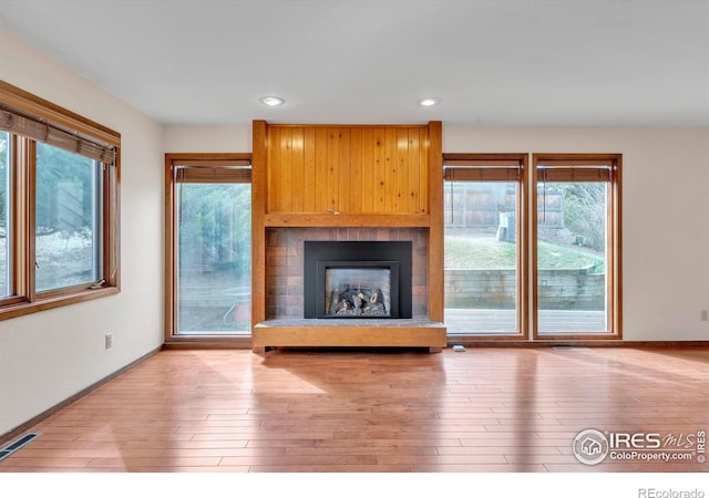 4570 Macarthur Dr, Boulder, CO 80303 - unfurnished living room featuring wood finished floors, baseboards, a large fireplace, and recessed lighting