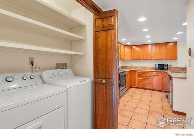 4570 Macarthur Dr, Boulder, CO 80303 - laundry room featuring washing machine and dryer, light tile patterned floors, and recessed lighting