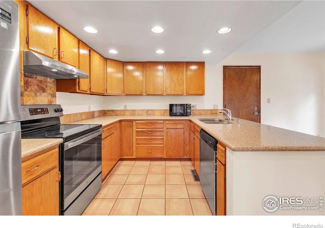 4570 Macarthur Dr, Boulder, CO 80303 - kitchen with stainless steel appliances, under cabinet range hood, a sink, a peninsula, and light tile patterned floors