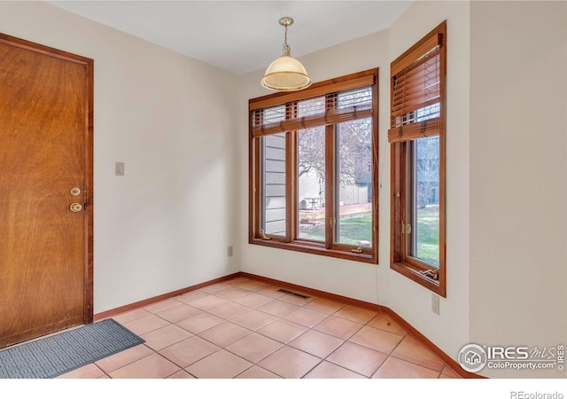 4570 Macarthur Dr, Boulder, CO 80303 - entrance foyer featuring healthy amount of natural light, light tile patterned floors, and baseboards