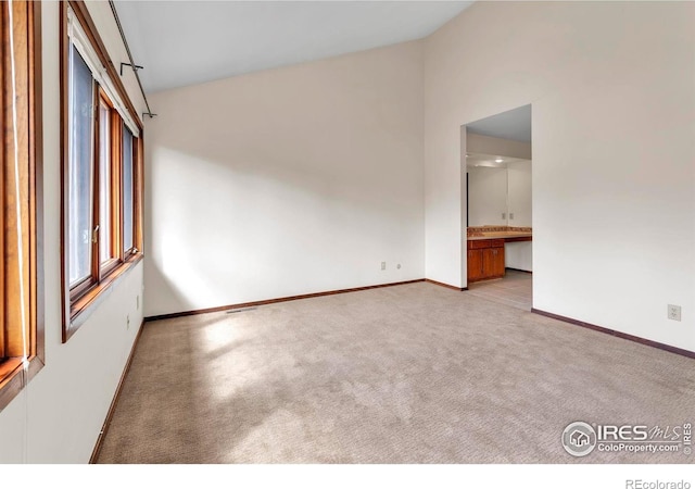 4570 Macarthur Dr, Boulder, CO 80303 - carpeted spare room with baseboards and high vaulted ceiling