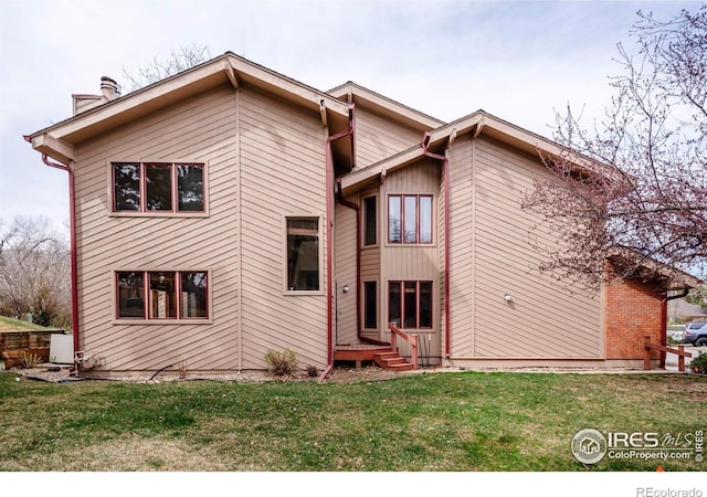 4570 Macarthur Dr, Boulder, CO 80303 - back of house featuring a chimney and a lawn