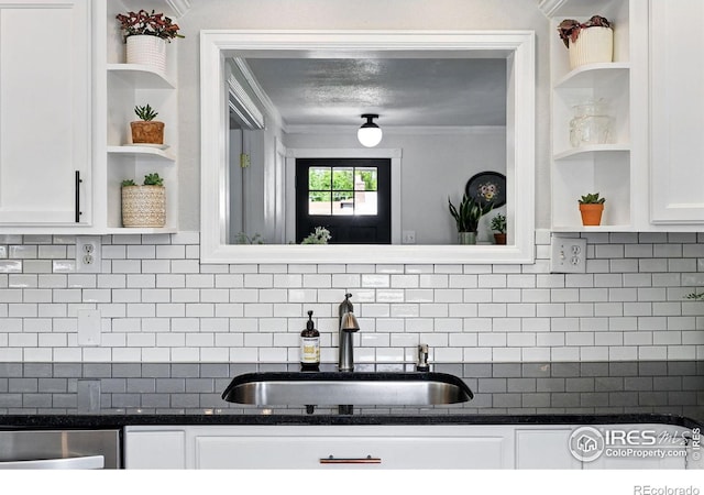 8290 Chase Way, Arvada, CO 80003 - kitchen featuring open shelves, a sink, crown molding, white cabinetry, and decorative backsplash