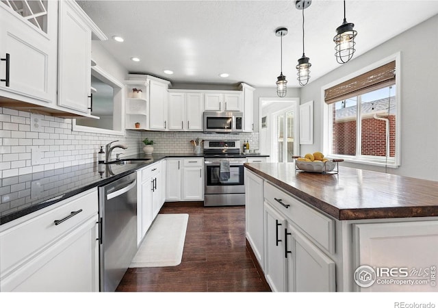 8290 Chase Way, Arvada, CO 80003 - kitchen with stainless steel appliances, a sink, open shelves, dark wood-style flooring, and white cabinets