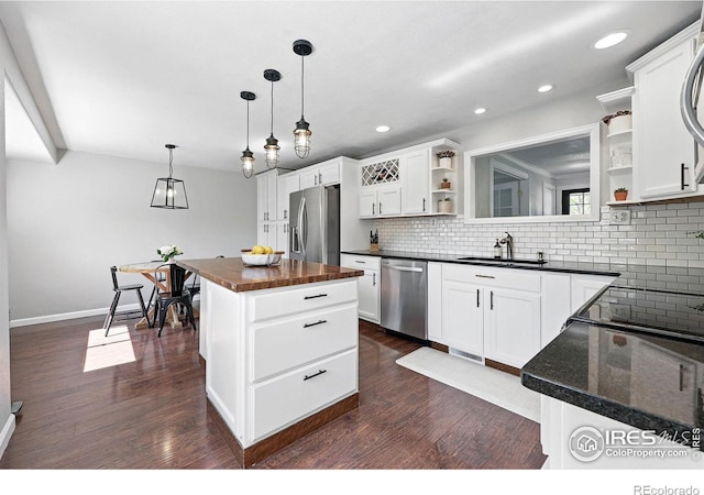 8290 Chase Way, Arvada, CO 80003 - kitchen featuring open shelves, appliances with stainless steel finishes, a sink, a center island, and backsplash