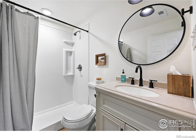 8290 Chase Way, Arvada, CO 80003 - bathroom featuring vanity, curtained shower, and toilet