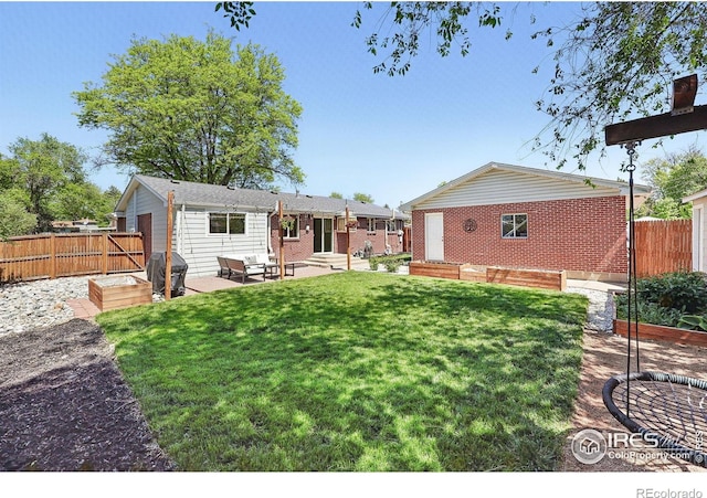 8290 Chase Way, Arvada, CO 80003 - back of property with a patio area and brick siding