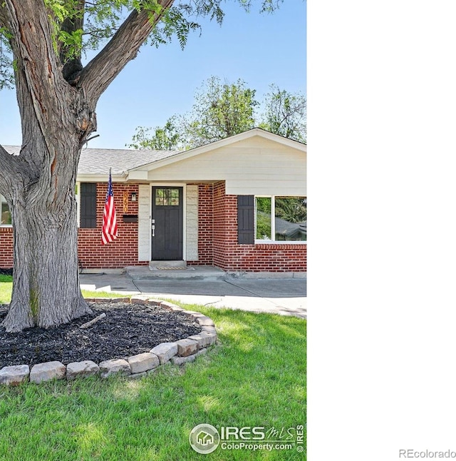 8290 Chase Way, Arvada, CO 80003 - single story home with brick siding and a front lawn