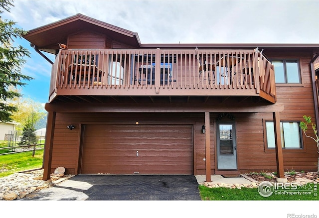1443 Matthew Cir, Estes Park, CO 80517 - view of front facade with an attached garage, driveway, and a balcony