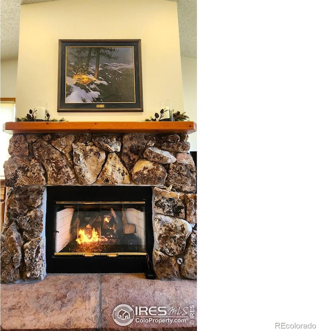 1443 Matthew Cir, Estes Park, CO 80517 - detailed view of a stone fireplace and a textured ceiling