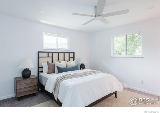 4601 S Lipan St, Englewood, CO 80110 - carpeted bedroom featuring multiple windows, baseboards, and ceiling fan
