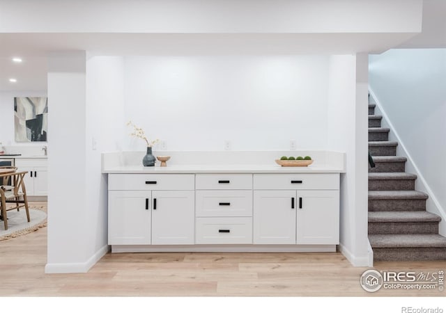 4601 S Lipan St, Englewood, CO 80110 - bar with light wood-style floors, stairway, baseboards, recessed lighting, and a sink